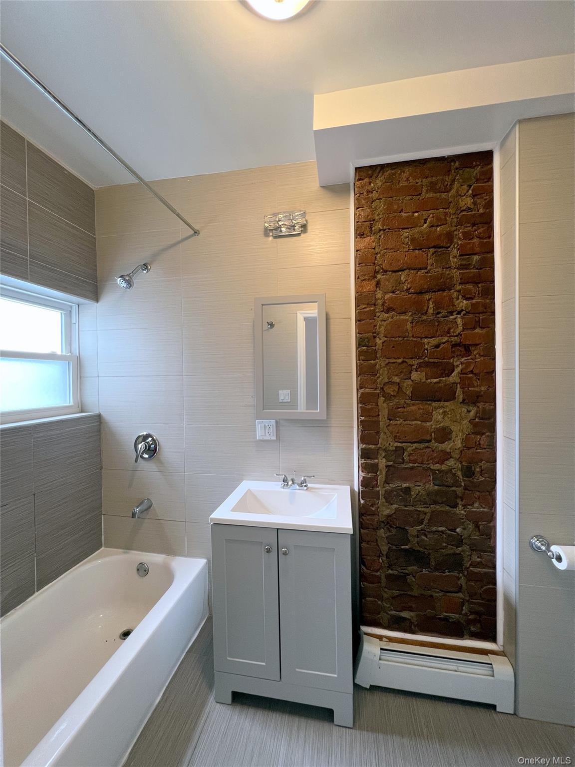 Full bath with baseboard heating, shower / washtub combination, vanity, and tile patterned flooring