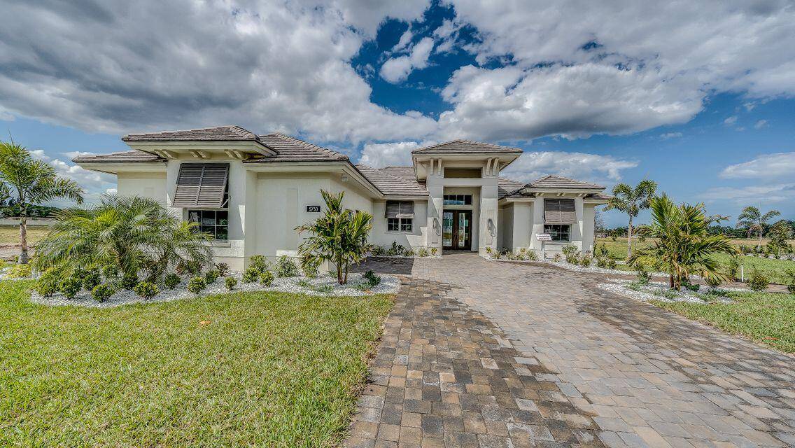 Welcome to 5690 Bent Pine Square, an exquisite coastal style lakefront residence situated in the esteemed Bent Pine Preserve golf course enclave.