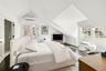 Bedroom with lofted ceiling, access to exterior, dark wood-style floors, and a wall mounted AC