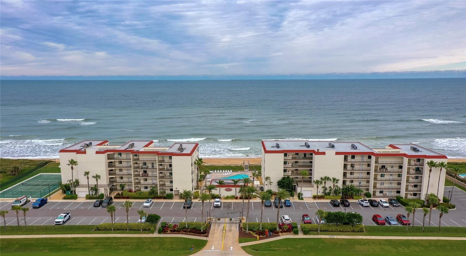 This beautifully maintained oceanfront community features two mid-rise buildings, a central pool area, and tennis courts—all nestled along the coast w