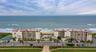 This beautifully maintained oceanfront community features two mid-rise buildings, a central pool area, and tennis courts—all nestled along the coast w