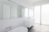 Bathroom featuring tile patterned floors, a tub to relax in, and vanity