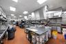 Kitchen featuring a paneled ceiling, stainless steel countertops, and tile patterned floors
