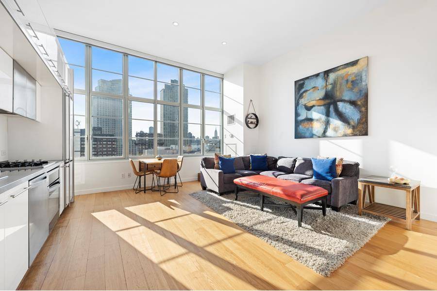 This 1, 298 square foot residence features over sized insulated loft windows with motorized, black out shades, beautiful wide planked wood floors, and unobstructed western exposures showcasing panoramic views of ...