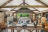 Living room offers views of swimming pond, stream