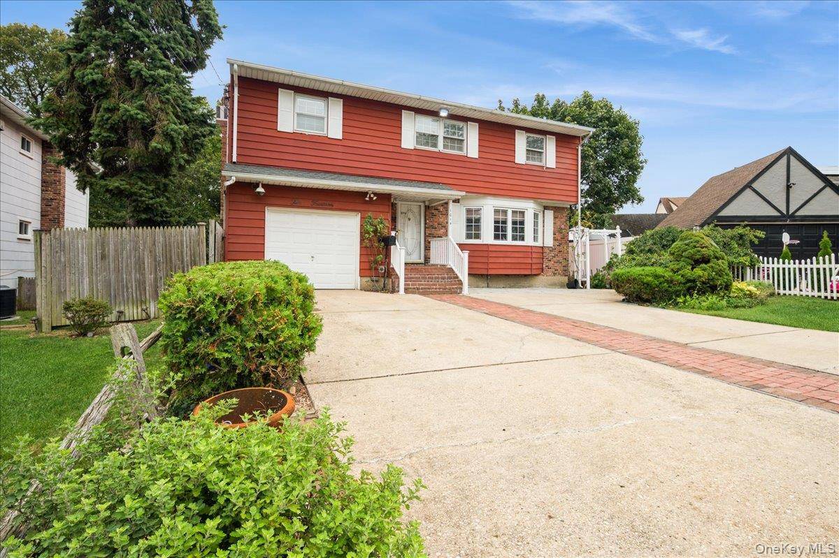 Contemporary 4 bedroom home featuring a spacious living room, formal dining room, eat in kitchen, and a cozy family room with a working wood burning fireplace and skylight.