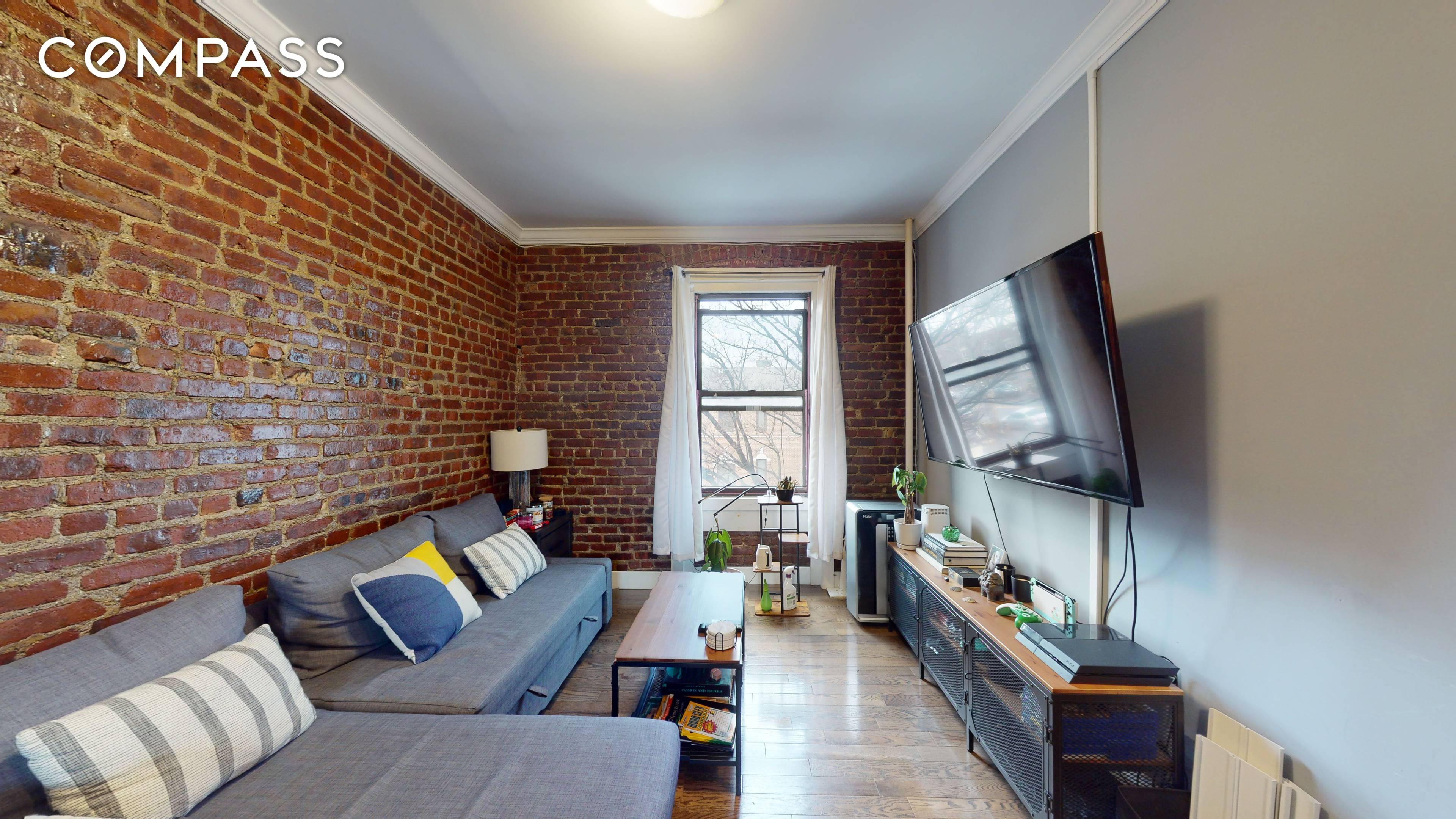 The newly renovated apartment has a high end kitchen with stainless steel appliances and bath finishes with exposed brick.