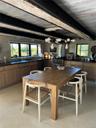 Dining room with finished concrete floors and a wooden ceiling with exposed beams