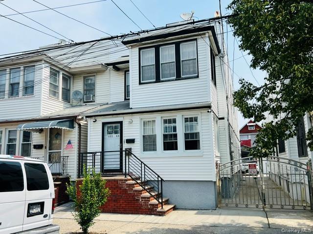 Two-story white siding exterior with contrasting black window frames