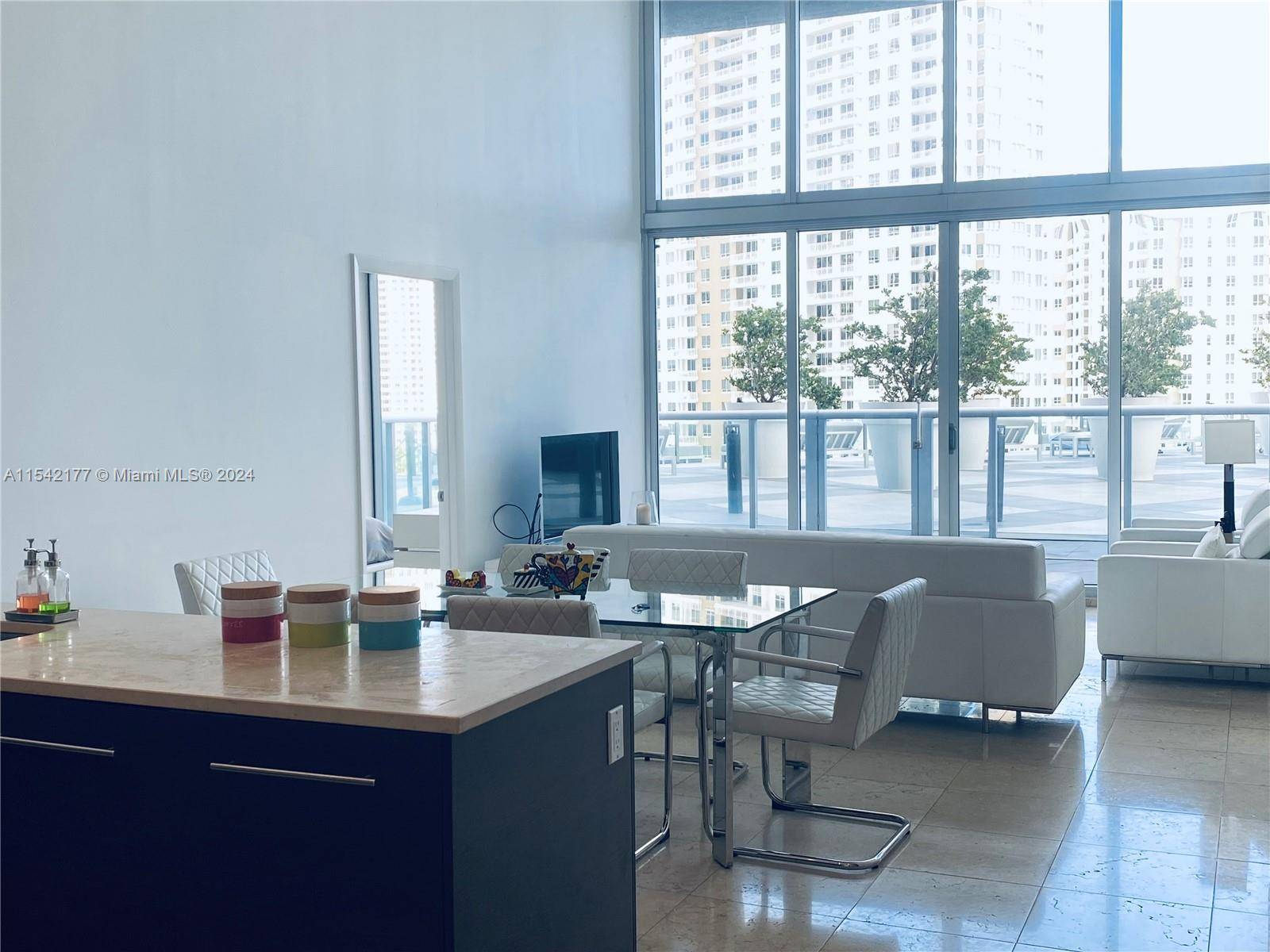 ABSOLUTLEY STUNNING 16' HIGH FLOOR TO CEILING WINDOWS 2BEDROOM 2BATHROOM WITH DEN FULLY FURNISHED, SITUATED RIGHT ON THE ICON BRICKELL POOL DECK OVERSIZED BALCONY PRIVATE PATIO AREA.