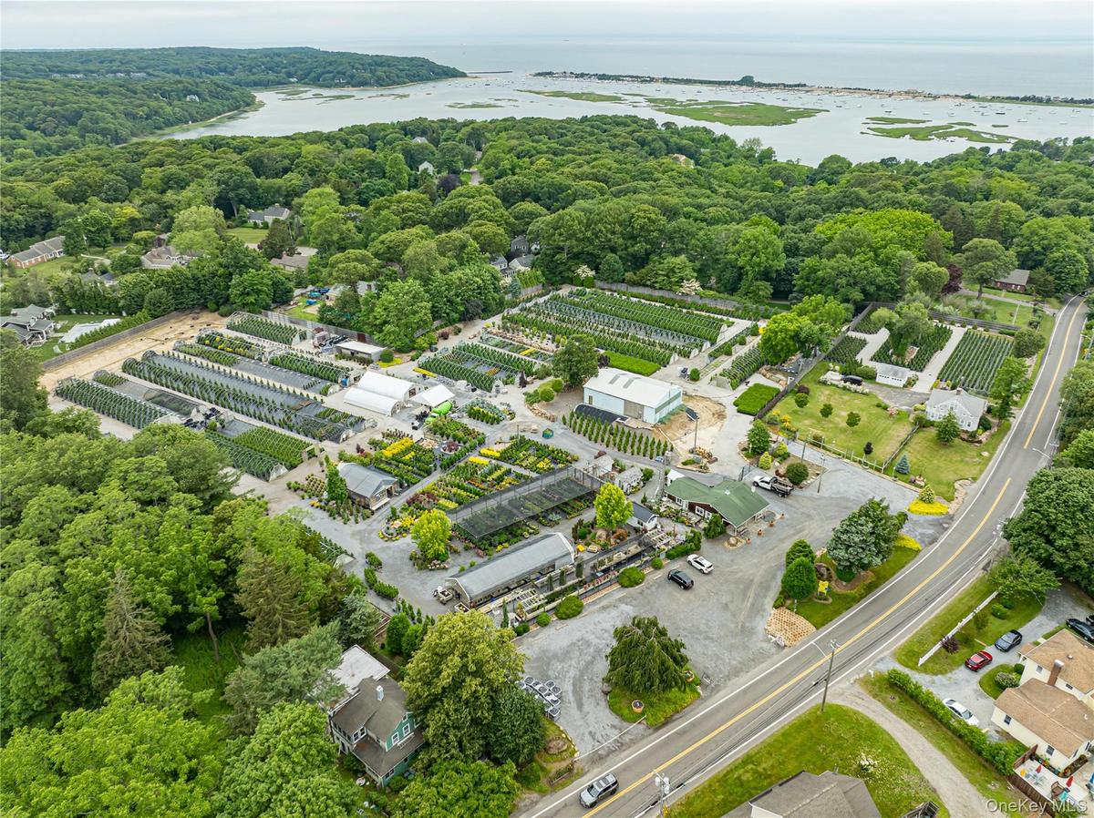 Aerial view of property and surrounding area featuring a nearby body of water