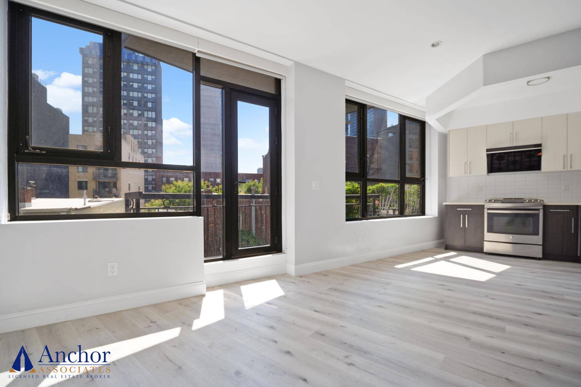 Enter a beautiful open space, bathed in natural light coming through the HUGH WALL OF WINDOWS !
