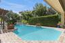 Large hedge provides privacy. Pool has baja shelf for that tanning in the water
