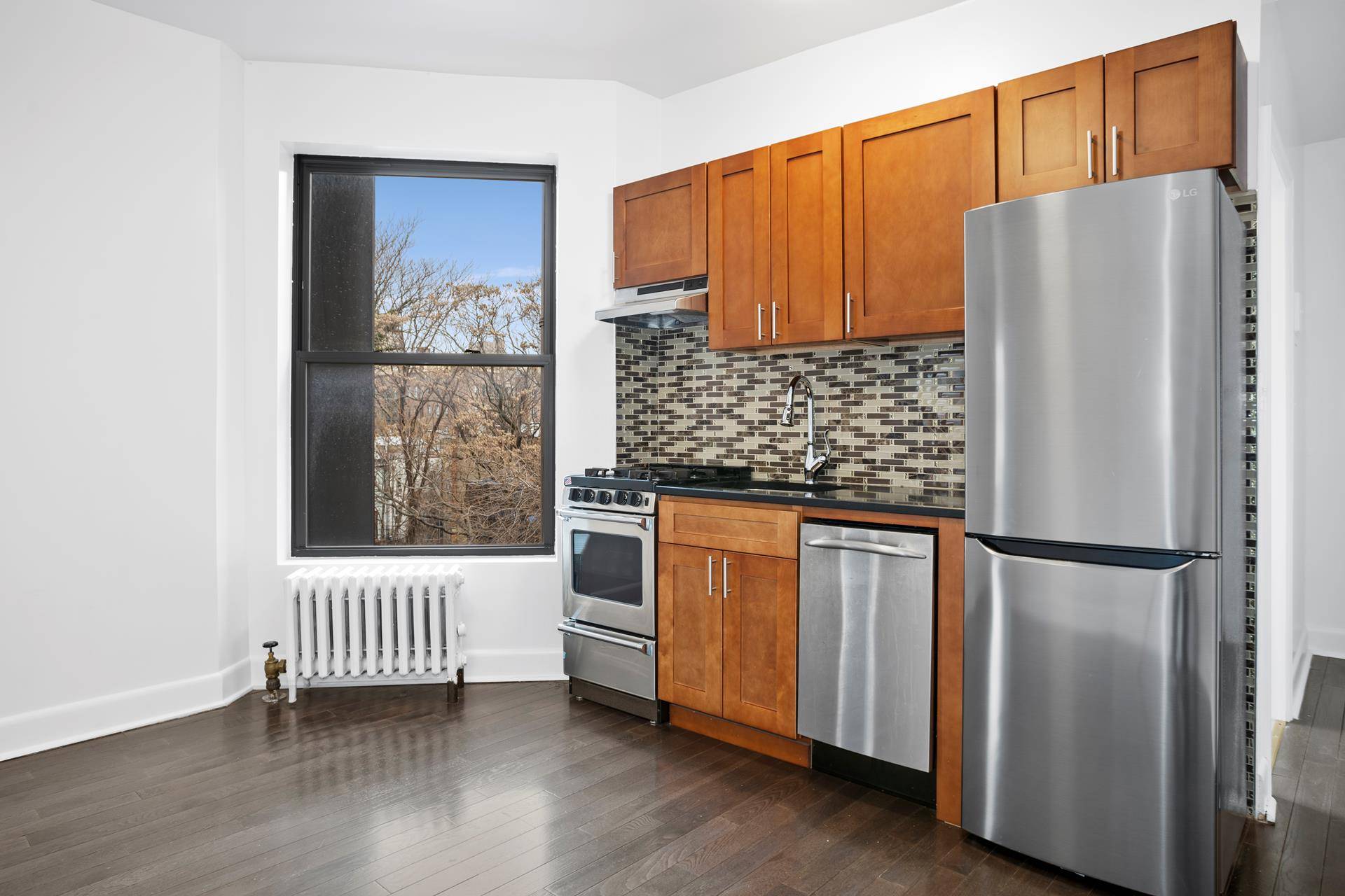 Located on the fifth floor of a walk up building, this is a sunny, renovated two bedroom one bath home, with the bathroom having a window.