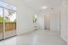 Unfurnished bedroom featuring light marble finish floors, radiator heating unit, and access to outside