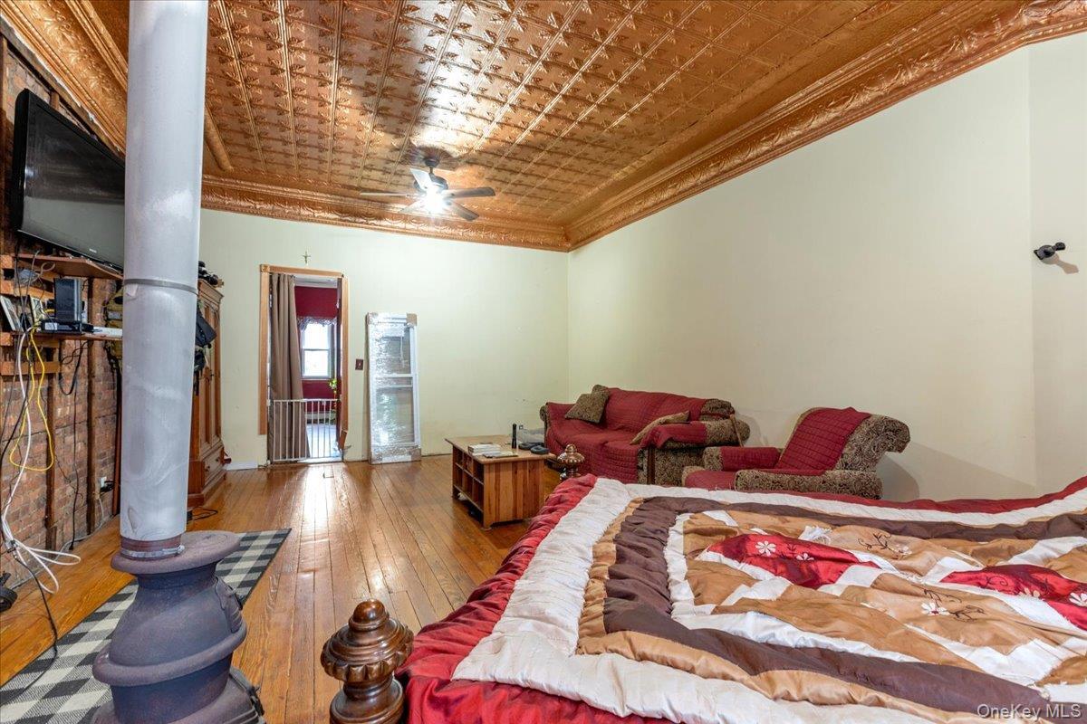 Bedroom featuring crown molding and wood-type flooring