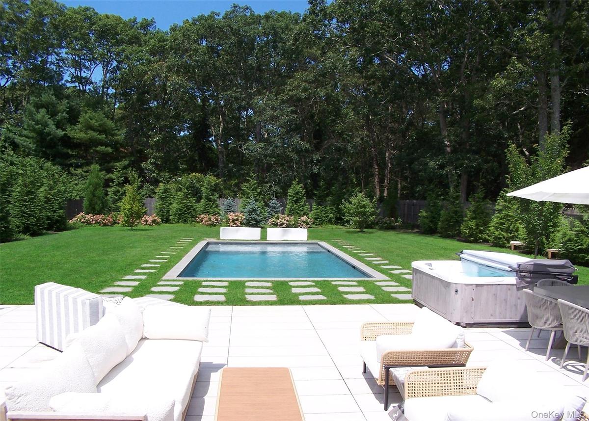 Swimming pool with a yard, outdoor lounge area, and a patio area