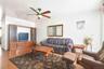 Living area featuring wood finished floors and ceiling fan