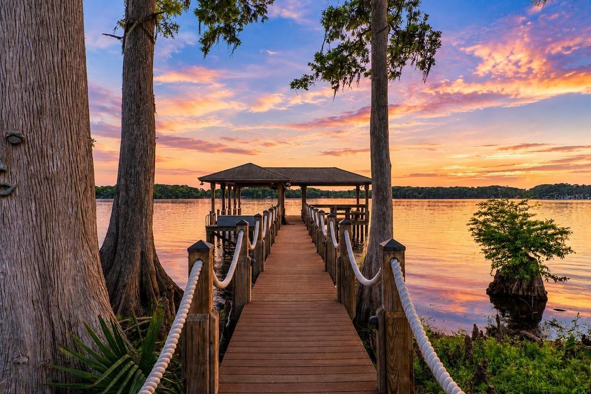 Boat Dock104 Feet Long Wooden Boat Dock23 Ft +/- Boat Lift with a remote dropDual Jet Ski LiftsGazebo with Wooden Table and BenchBuilt In StorageEquip