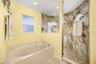 Primary bath with walk in shower and Jet Jacuzzi tub