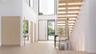 A striking custom pivot door opens to a light-filled foyer defined by floating stairs and seamless white oak flooring. With a discreet powder room and