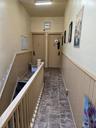 Hallway featuring dark stone finish flooring