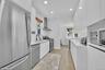 Bright kitchen with light wood-finish flooring and recessed lighting