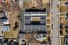 Multi-unit residential complex featuring flat roofs and multiple parking areas