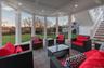 Sunroom / solarium featuring an outdoor living space, a patio area, beamed ceiling, and coffered ceiling