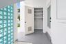 Outdoor Storage closet and area to park bicycles on the gravel behind the blue wall