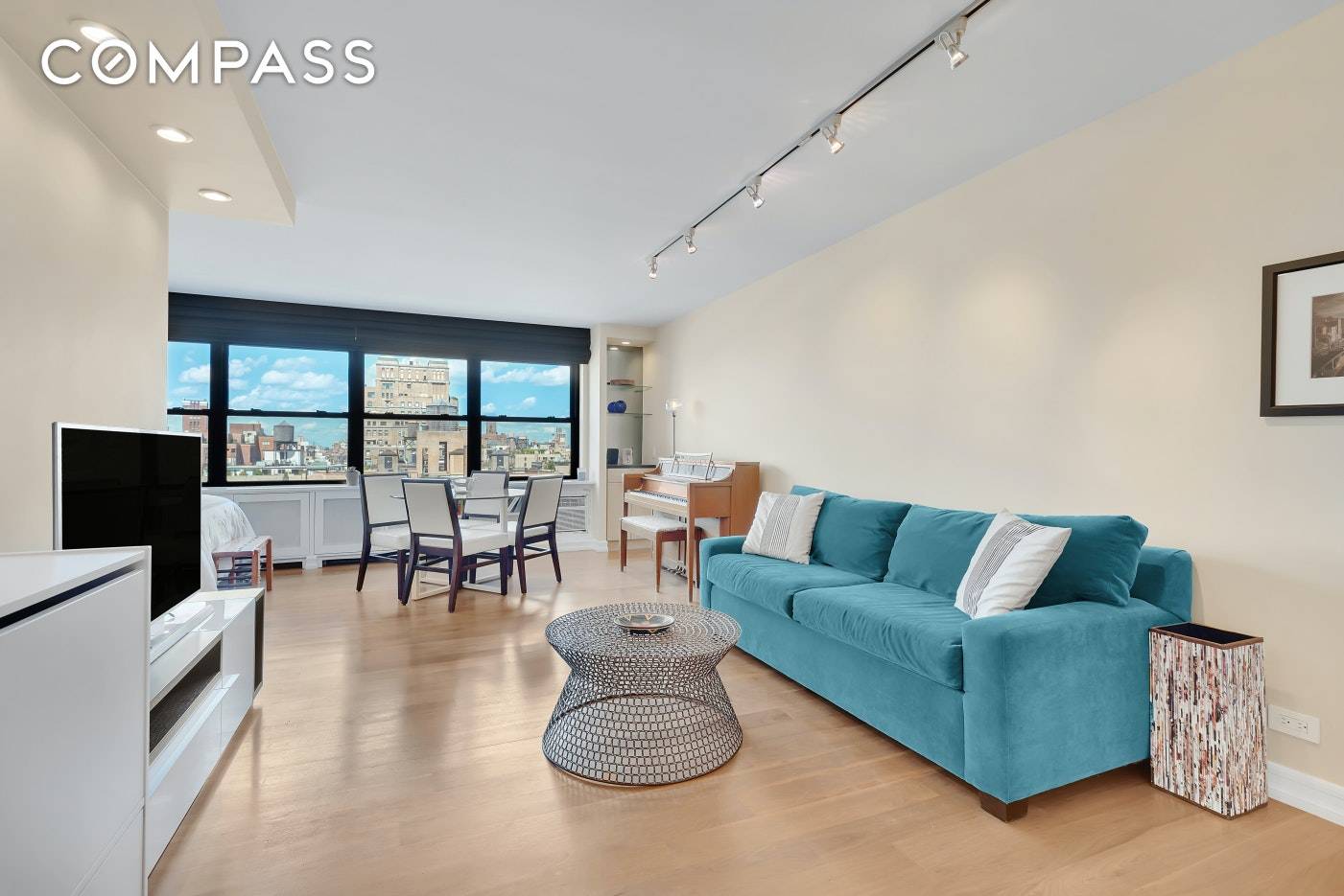 Spacious and open Alcove Studio with panoramic views, featuring the historic UWS rooftops and the Hudson River.