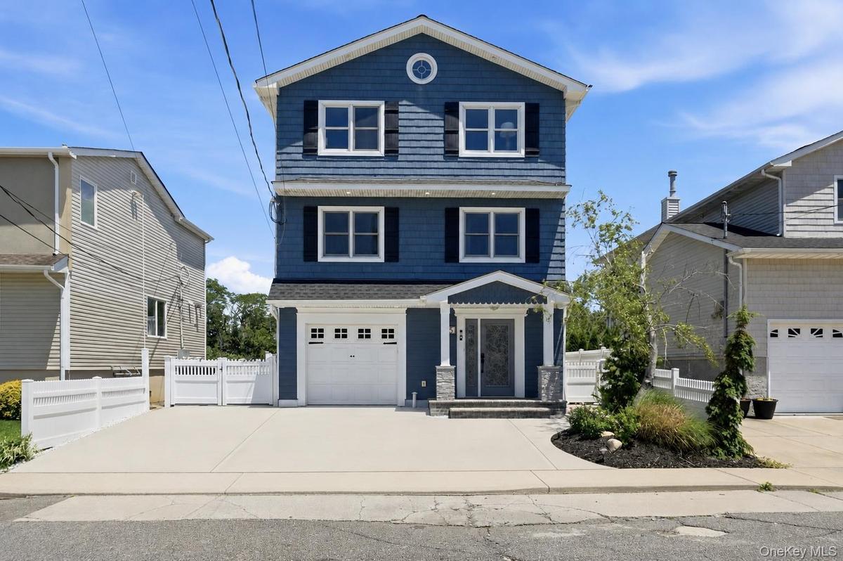Three-story residence featuring blue siding with white trim and black shutters