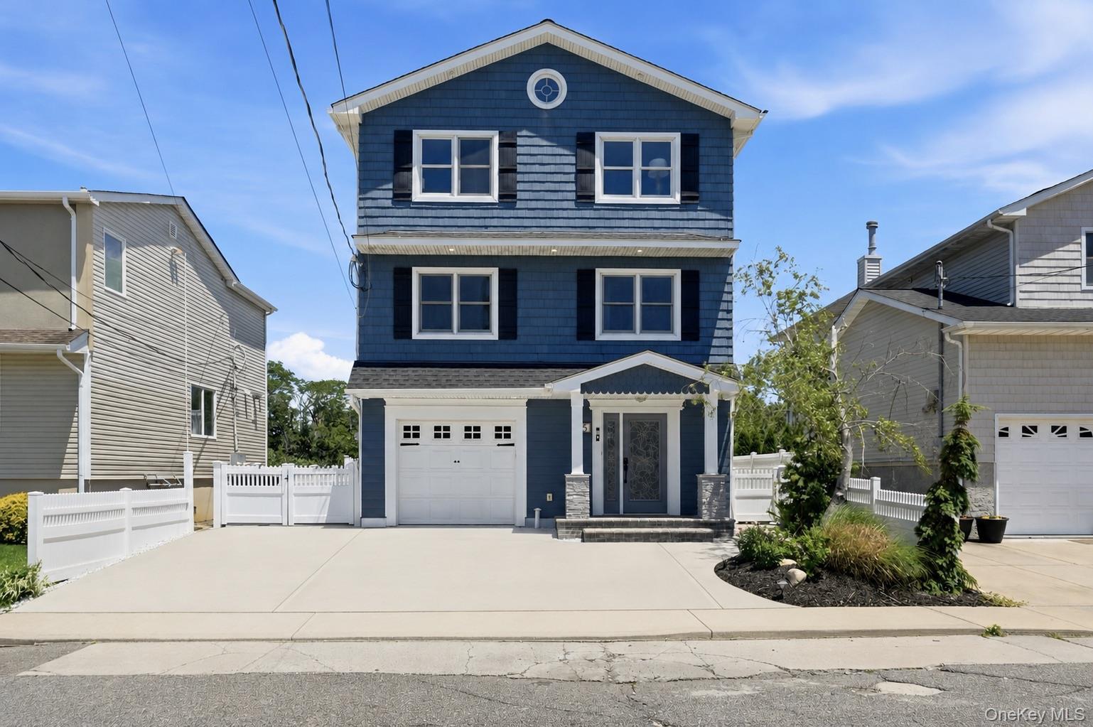Three-story residence featuring blue siding with white trim and black shutters