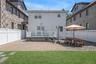 Brick paved patio qnd grass in the backyard