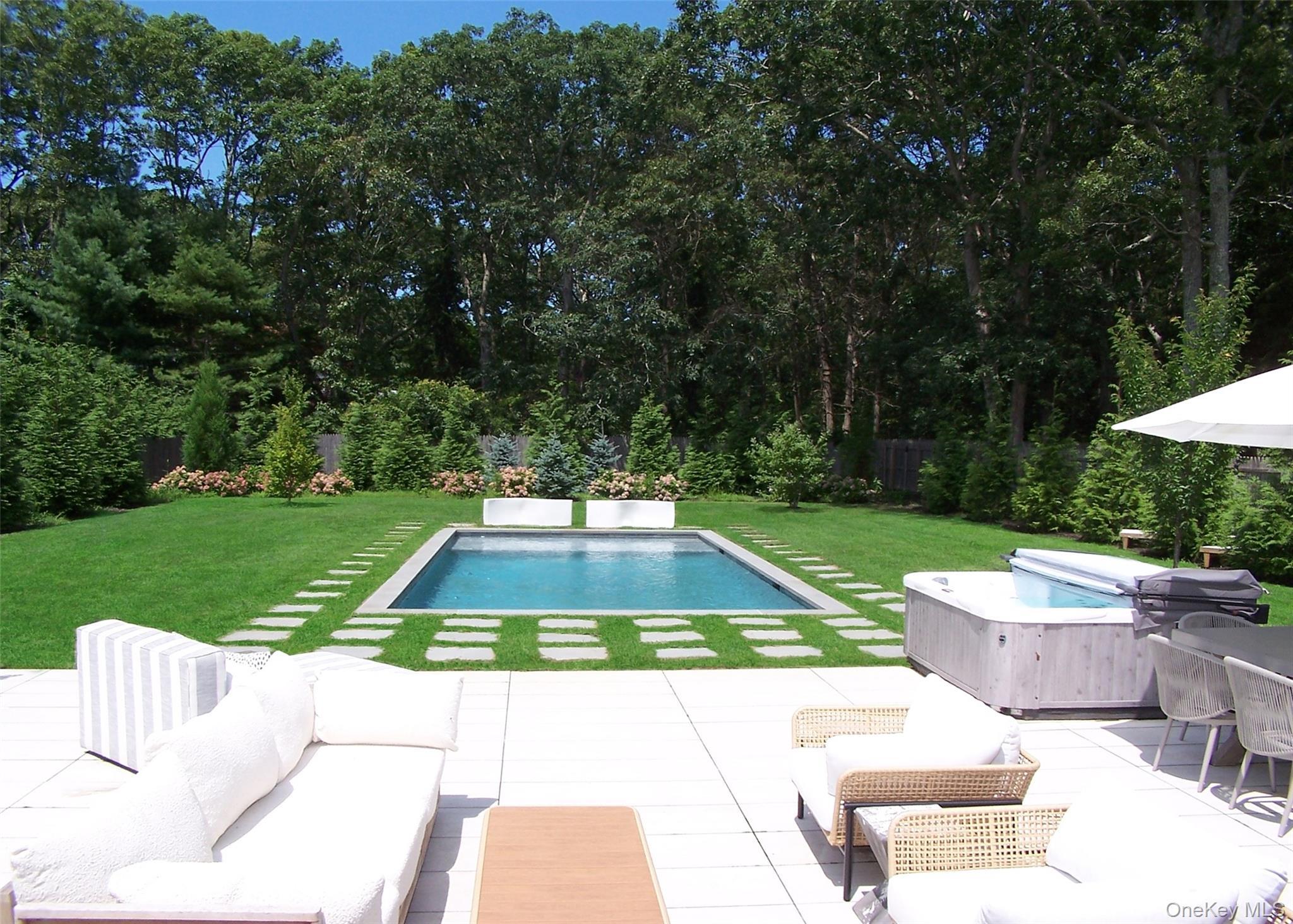 Swimming pool with a yard, outdoor lounge area, and a patio area