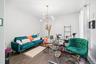 Spacious room featuring wood-finish flooring and a contemporary multi-arm chandelier