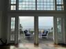 Doorway featuring a water view, wood-type flooring, and a high ceiling