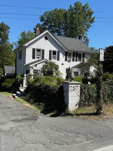 View of front of home with a chimney