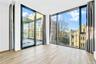 Unfurnished room with expansive windows and light wood-style floors