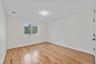 Unfurnished room featuring light wood finished floors and baseboards