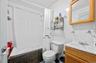 Full bath with tile walls, tiled shower / bath, and vanity