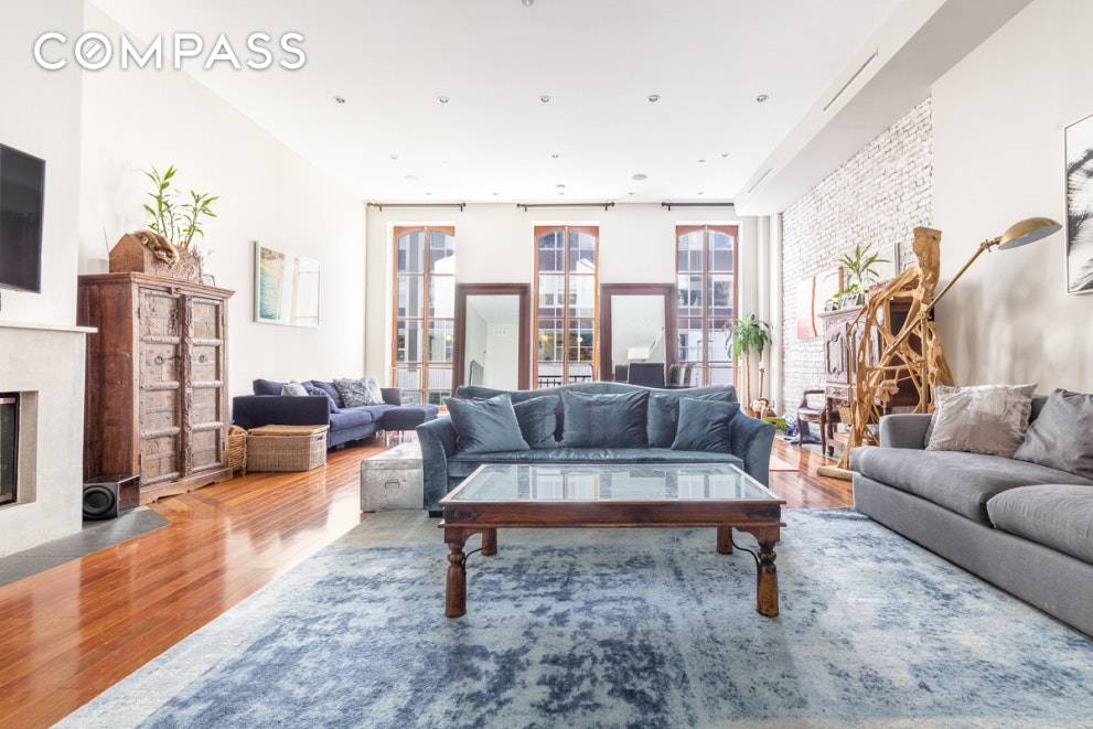 Spectacular 2 bedroom and 3 full bathroom TriBeCa Loft featuring soaring 15 ft ceilings, south facing floor to ceiling mohagony custom arched windows, central air conditioning, a wood burning fireplace ...