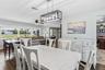 Dining with a view of the expansive living room windows