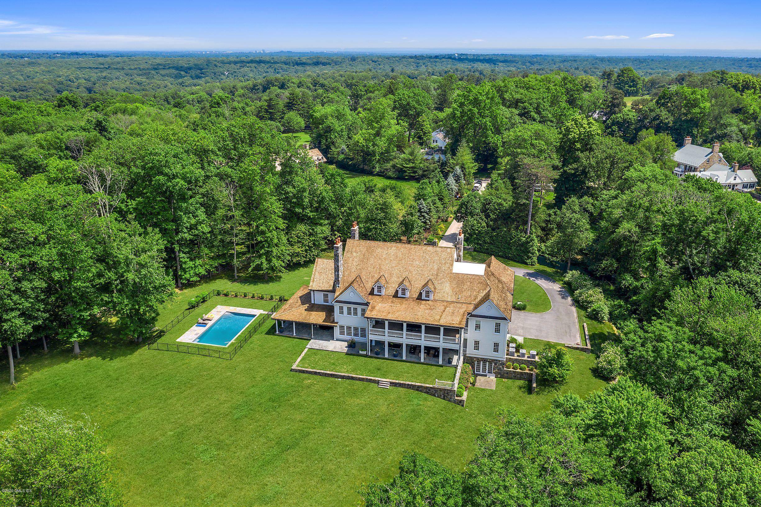 Magnificent 2013 Georgian Colonial situated on 4 private acres with a swimming pool plus room for tennis set off Round Hill Road in the bucolic back country of Greenwich.