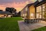 Yard at dusk featuring a patio area, outdoor dining area, an outdoor living space, and a yard