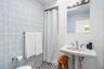 Bathroom featuring tile walls and curtained shower