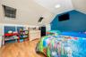 Bedroom with light wood finished floors, vaulted ceiling, and a skylight