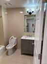 Bathroom with tile walls, light tile patterned floors, vanity, and bathtub / shower combination
