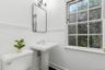 Bathroom with toilet, a sink, and baseboards