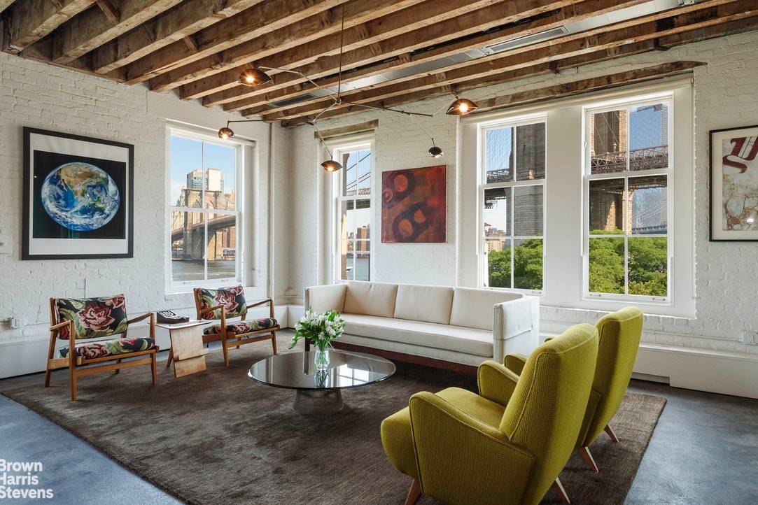 This classic waterfront loft overlooking Brooklyn Bridge Park and the East River, with spectacular views of the Manhattan skyline, was beautifully renovated by Studio DB, renowned architects.